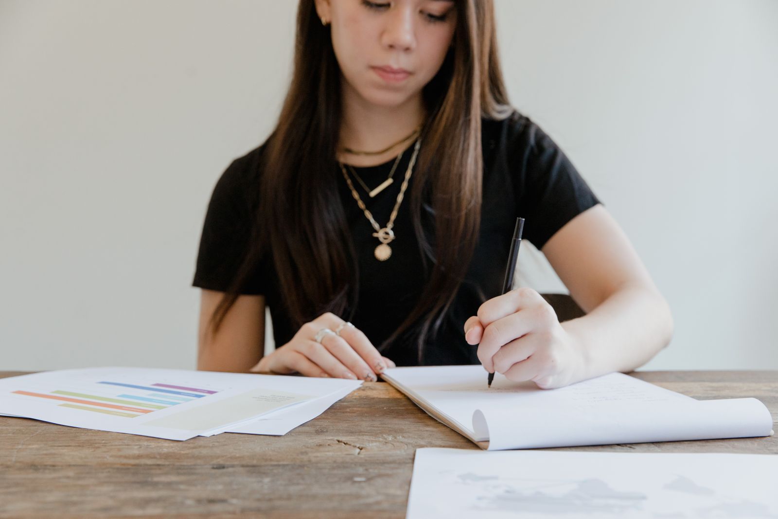 Freelance writer reviewing printed pages and marking notes by hand